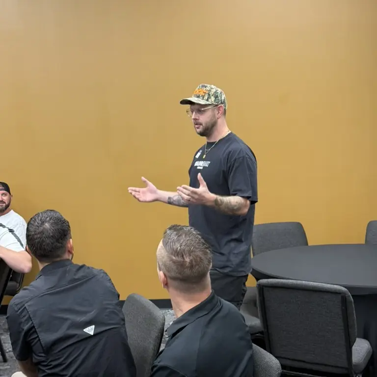 A member standing and sharing with the group at a twelve gathering