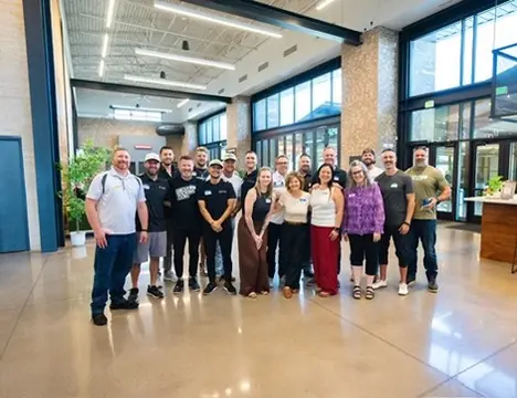 Members of twelve standing together for a group photo